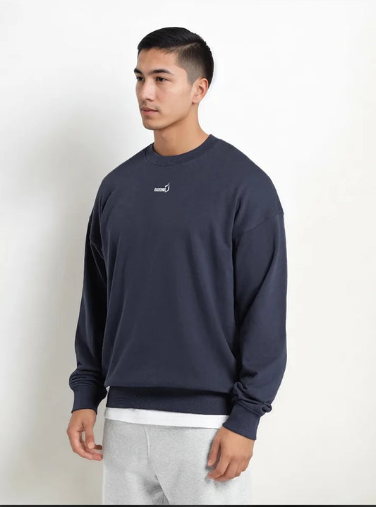 An athlete wearing oversized sweatshirt from Radowl brand this sweatshirt name is "Grind Oversized Sweatshirt Navy" this sweatshirt is navy in colour and Radowl logo with its signature printed on it, this sweatshirt made of Hevay polycotton which make this best sweatshirt for winters. This product have sung fit which gives an unrestricted movement during workouts.