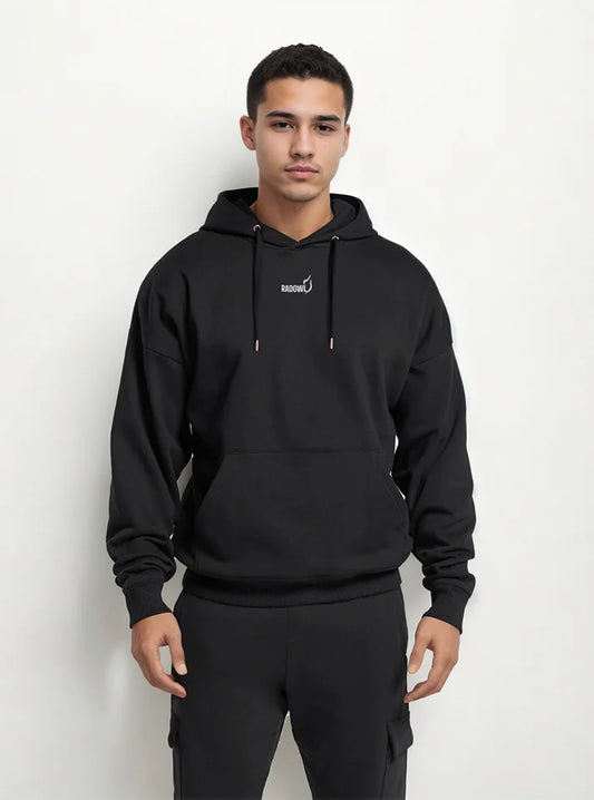A gym athlete wearing black gym hoodie from Radowl brand, this hoodie name is "Legacy Oversized Heavy Hoodie Black" this hoodie have heavy fabric to keep you warm and at front radowl logo with its signature printed and at the back side "Radowl" printed with white colour in bold fonts
