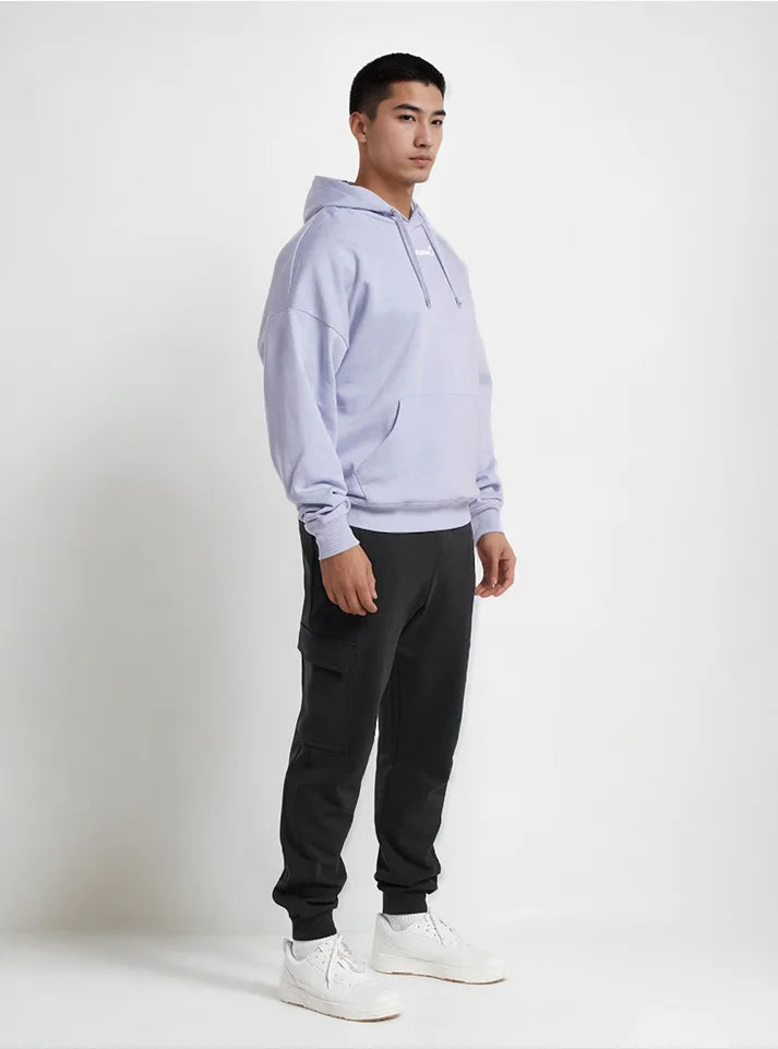 This image of an athlete wearing lavender color hoodie from Radowl Gym wear brand and the product name of this hoodie is Slay Oversized Heavy Hoodie Lavender. This hoodie have snug fit which give you free movement during workout.