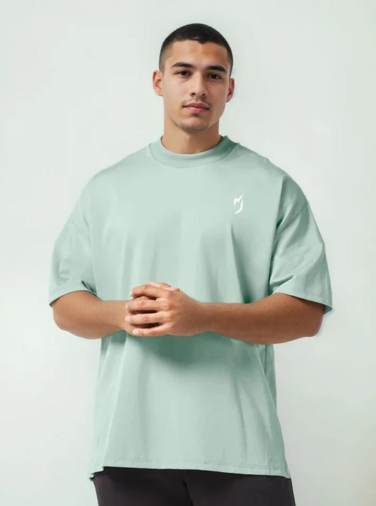Front view of a male model wearing oversized gym tshirts for winter with jade colour, this tshirt have Radowl gym wear brand logo, it's a perfect tshirt for workout because half sleeve give you un restricted movement and hevy terry fabric keeps you warm.