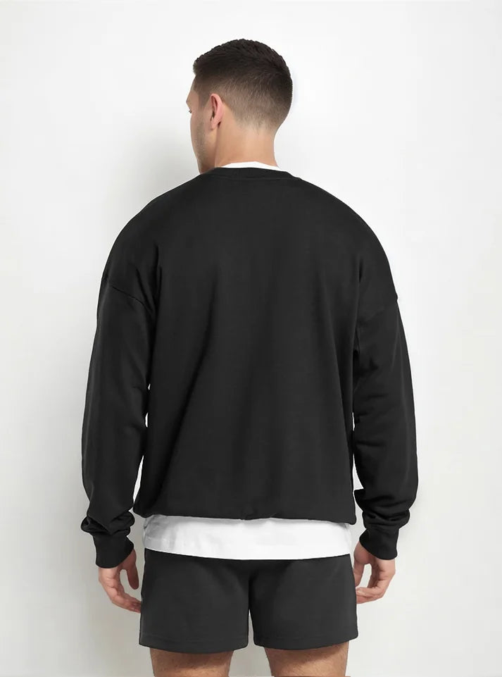 A male athlete wearing Radowl brand sweatshirt showing back view. The name of this product is "Grind Oversized Sweatshirt Black" Its a first choice mens to wear in Gym during winters.