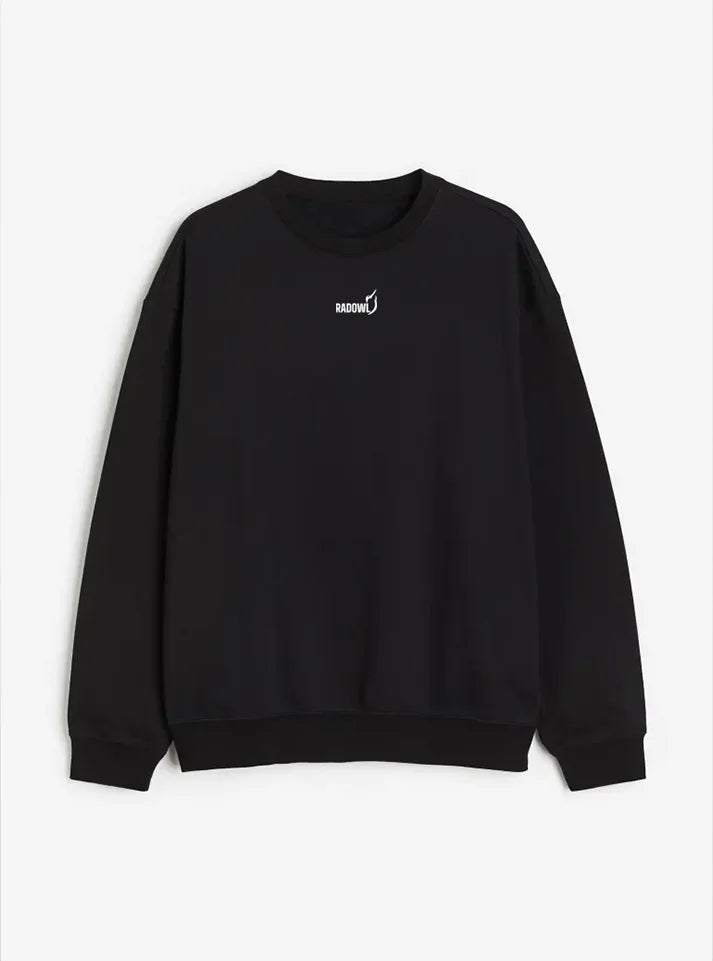 This images show Radowl Sweatshirt is lying on white background and this product name is "Grind Oversized Sweatshirt Black" it's black in colour and white colur Radowl logo and signature printed on it.