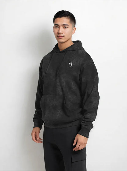 In this image a gym athlete is wearing Black acid washed sporty fit gym hoodie by Radowl gym wear Brand this product name is "Shadowlift Acid Wash Sporty Fit Gym Hoodie" this hoodie have sporty fit and Radowl logo is print with white colour.