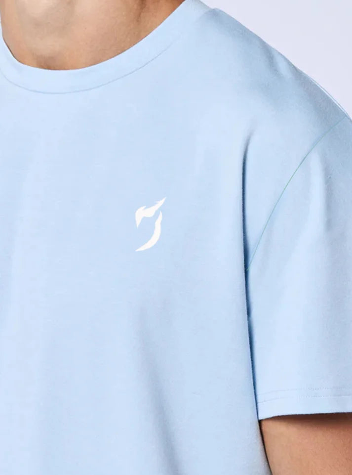 Close up image of strength heavyweight oversized gym tshirt ice blue color this photo shows the detail and radowl logo from up close.