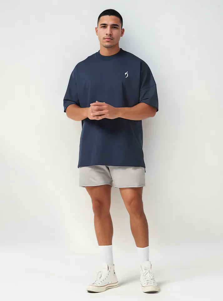 Front full photo of a model wearing radowl strength heavyweight oversized gym tshirt navy colour  this t-shirt made form heavy terry which keeps you warm during winters and this tshirt have Radowl logo which make it a best gym wear tee.
