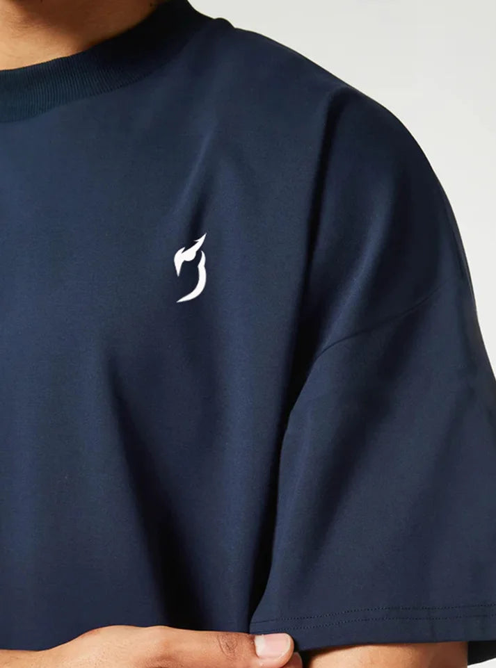 Close up image of strength heavyweight oversized gym tshirt navy color this photo shows the detail and radowl logo from up close.
